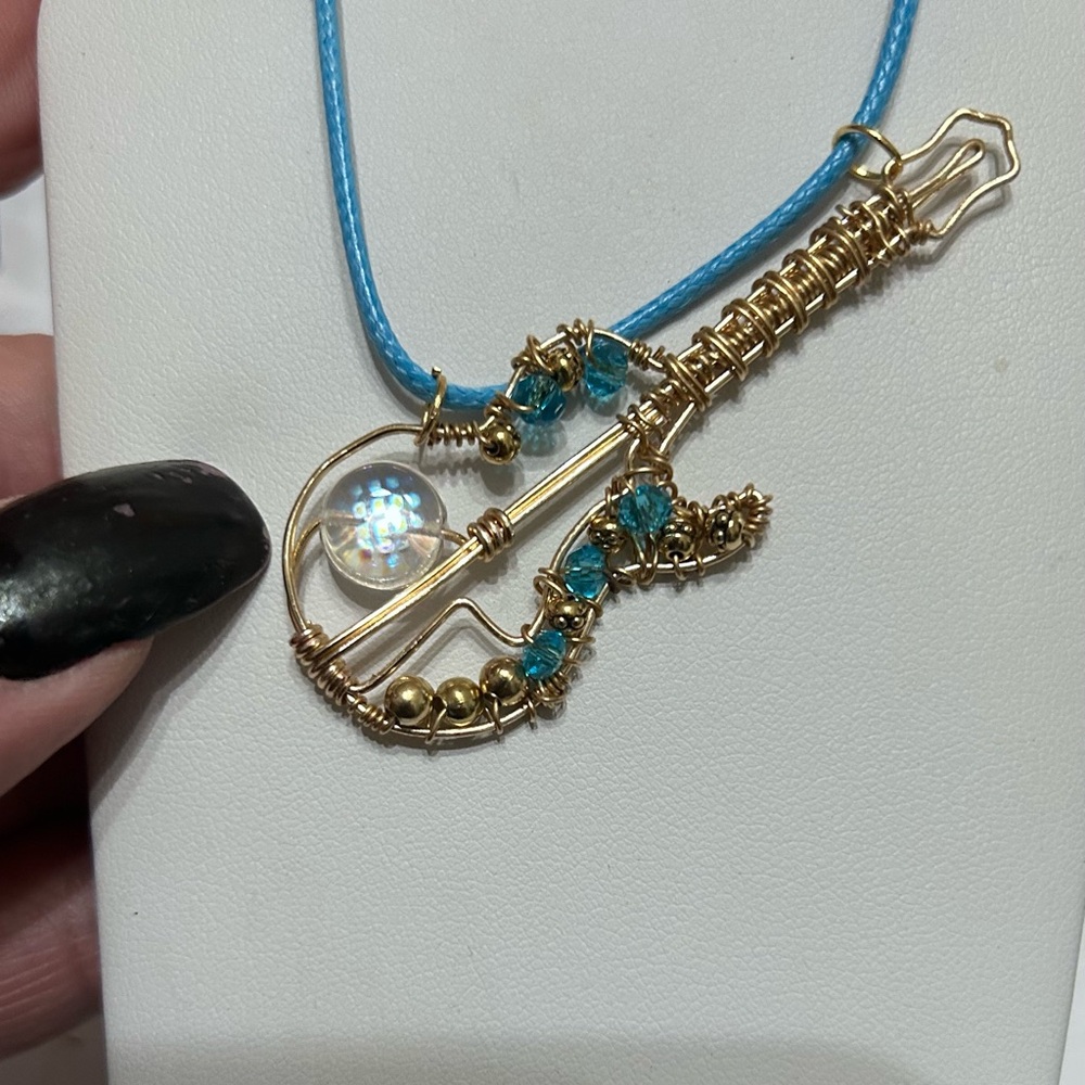 Handmade wire guitar necklace.